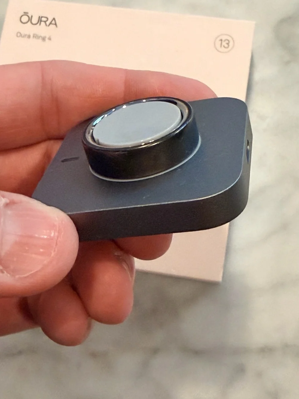 Oura Stealth Charging Dock on Blush Pink Box